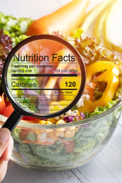 nutritional information concept. hand use the magnifying glass